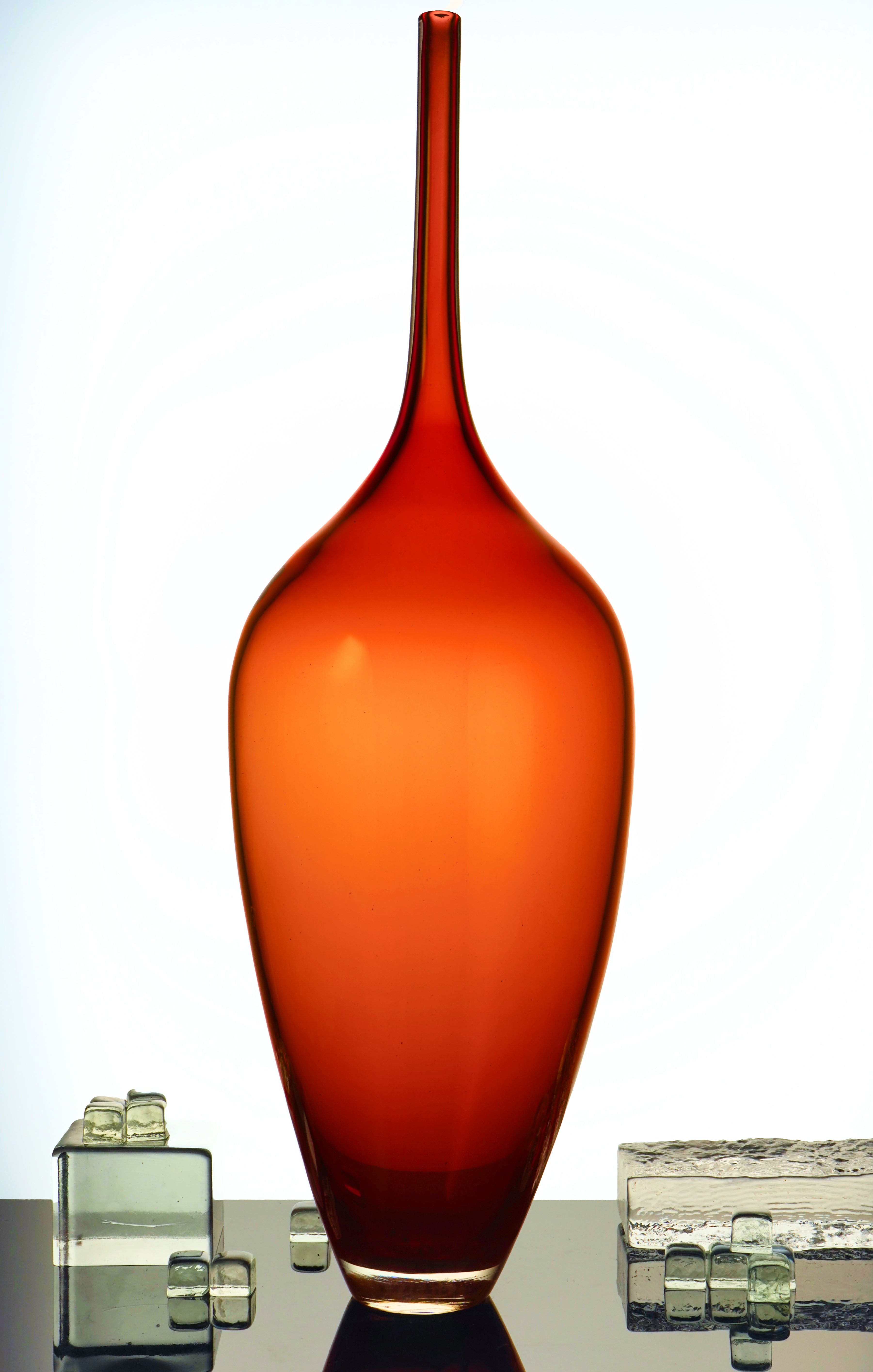 Edols & Elliott Red Glass Bottle Sculpture, handmade with exquisite craftsmanship. The vibrant red glass adds a pop of color and sophistication to any space.