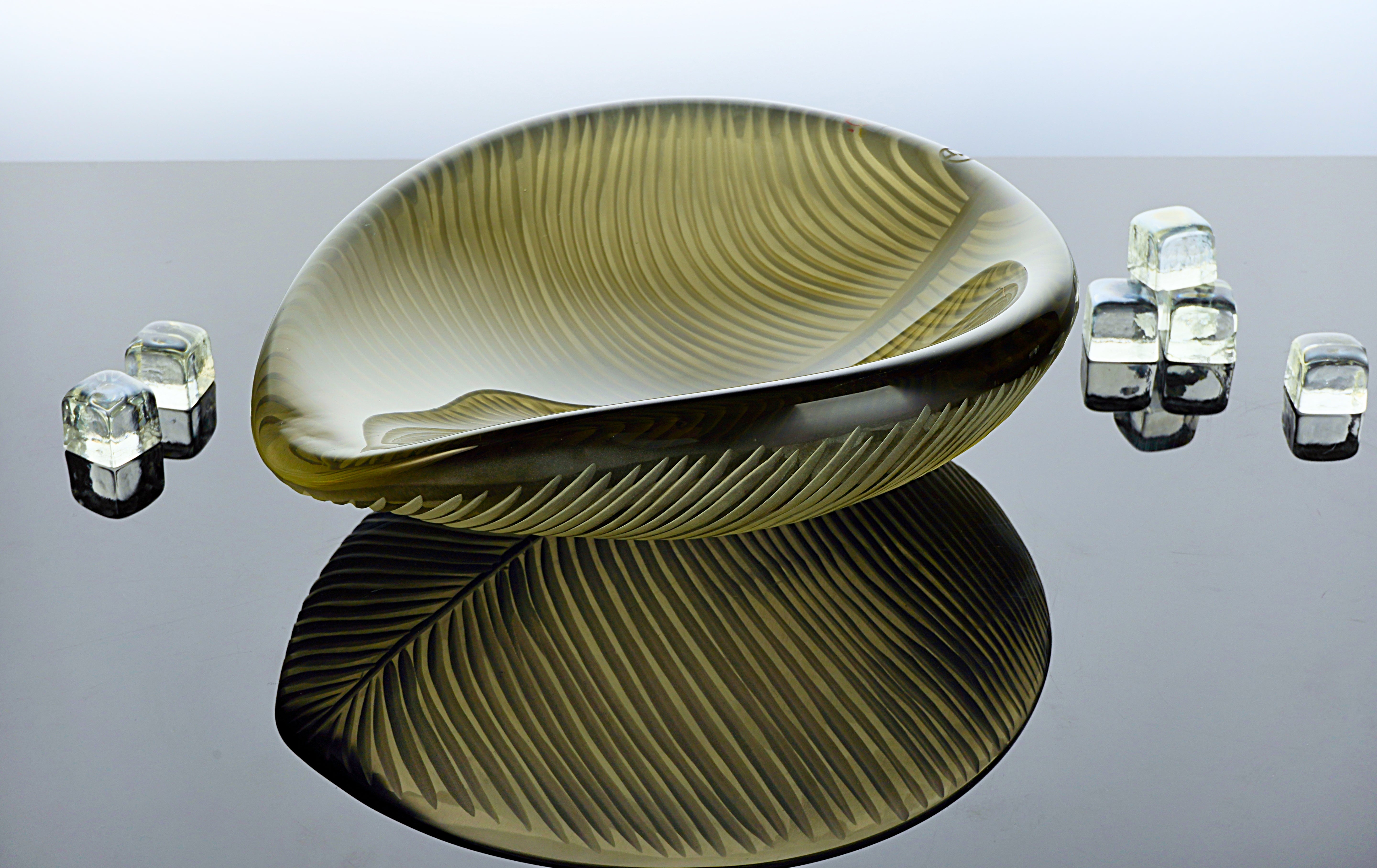 Handcrafted Murano glass leaf-shaped centerpiece with delicate streaks and vibrant layered colors. Each piece is individually blown, creating a unique design that's a luxurious addition to any elegant setting.