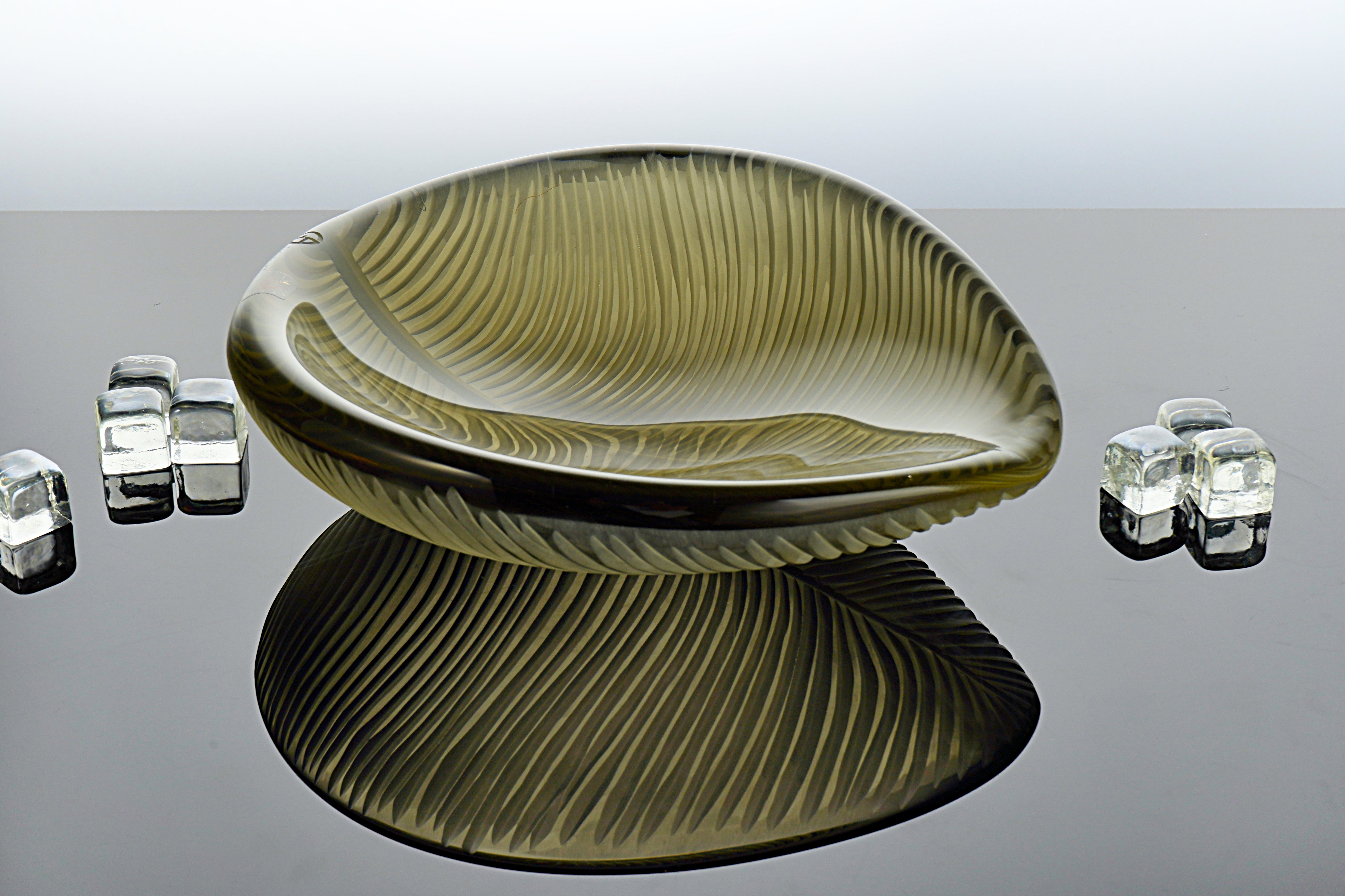 Handcrafted Murano glass leaf-shaped centerpiece with delicate streaks and vibrant layered colors. Each piece is individually blown, creating a unique design that's a luxurious addition to any elegant setting.