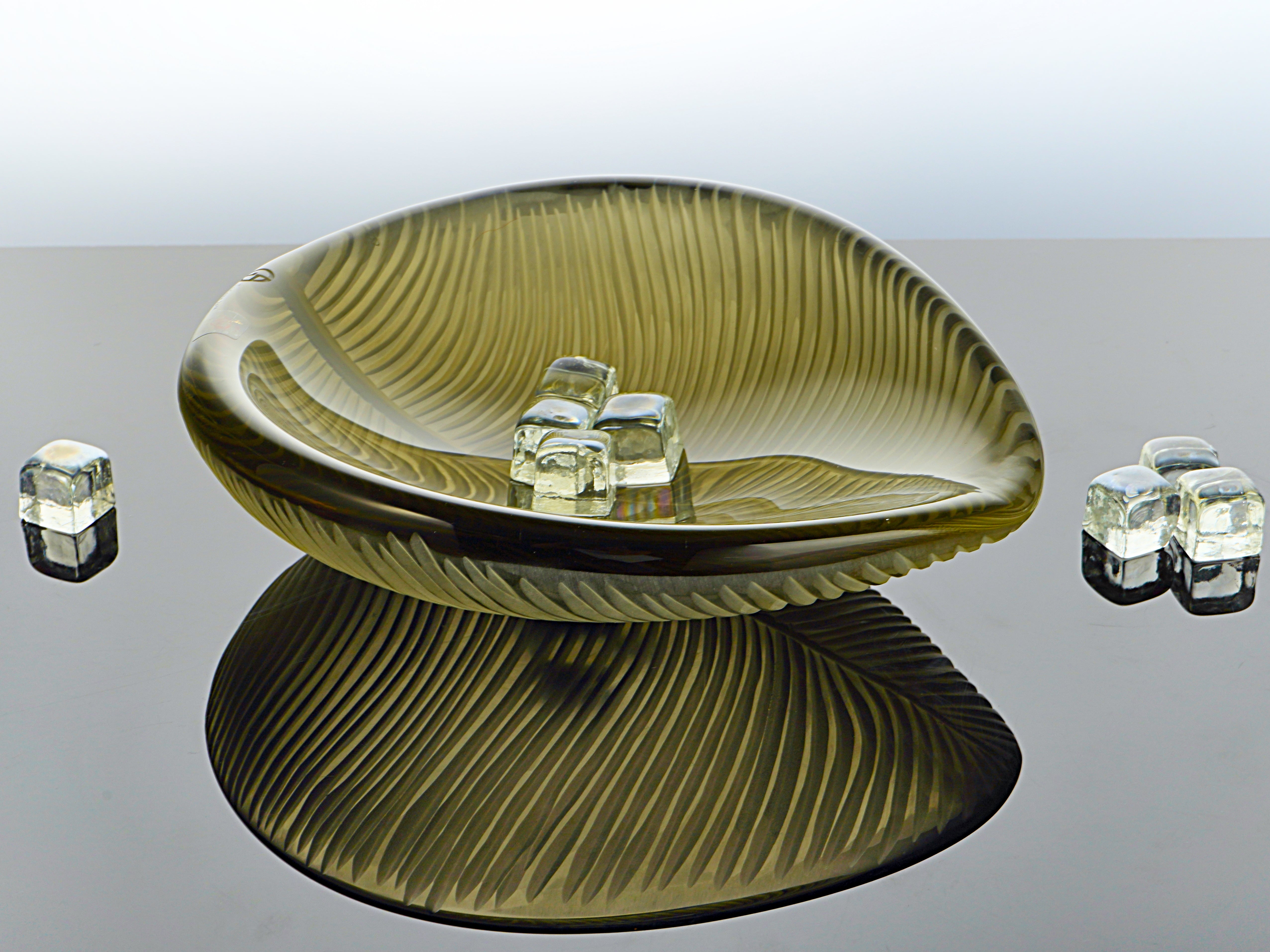 Handcrafted Murano glass leaf-shaped centerpiece with delicate streaks and vibrant layered colors. Each piece is individually blown, creating a unique design that's a luxurious addition to any elegant setting.